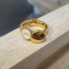 Demi bague dorée, cuir rond doré et œil doré émaillé blanc