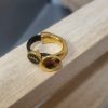 Demi bague dorée, cuir rond noir et oeil émaillé noir