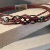 Bracelet mixte en cuir rond et son sigle infini noir
