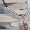 Collier femme en cuir rond tressé marron, longue plume or rosé