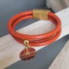 Bracelet femme en cuir rond orange et médaillon orange et étoile dorée