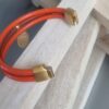 Bracelet femme en cuir rond orange et médaillon orange et étoile dorée