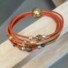 Bracelet femme en cuir rond orange et perles bronzes et argentées, tubes bronzes