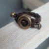 Bague en cuir marron tressé et passants bronze